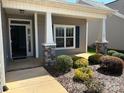 Inviting front porch with stone accents and manicured landscaping enhances the home's curb appeal at 906 Wisteria Way, Salisbury, NC 28146