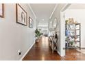 Elegant hallway with hardwood floors, decorative console table, and arched doorways at 10773 Sapphire Trl, Davidson, NC 28036