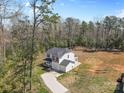 Expansive aerial view of home nestled in a wooded area, featuring a large yard and driveway at 109 Landon Ct, Shelby, NC 28152