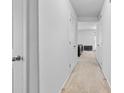 Bright hallway with neutral carpet, white walls, and multiple doors leading to various rooms at 109 Landon Ct, Shelby, NC 28152