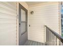 Apartment porch with gray door, doorbell, and light at 11063 Running Ridge Rd, Charlotte, NC 28226