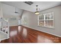 Bright and airy living room with vaulted ceilings, hardwood floors, and large windows at 11929 Kings Castle Ct, Charlotte, NC 28277