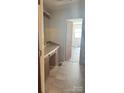 Bathroom with long vanity and tile floors leading to bedroom in need of cleaning at 143 Harvest Dr, Kings Mountain, NC 28086