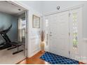Light-filled foyer features hardwood floors, wainscoting, and an elegant front door with sidelights at 14923 Colonial Park Dr, Huntersville, NC 28078