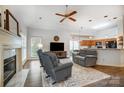 Open living room with fireplace, ceiling fan, hardwood floors, connecting to kitchen area at 1509 Burning Lantern Ln, Kannapolis, NC 28081
