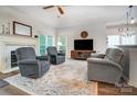 Cozy living room with fireplace, ceiling fan, hardwood floors, and neutral-toned furniture at 1509 Burning Lantern Ln, Kannapolis, NC 28081
