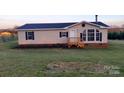 Charming home featuring neutral siding, a dark roof, and a quaint wooden porch at 1524 J Rhyne Reep Rd, Vale, NC 28168
