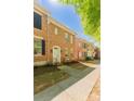 Beautiful brick townhome featuring classic black shutters and a tidy front garden, offering curb appeal at 165 Singleton Rd, Mooresville, NC 28117