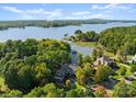 Stunning aerial view of waterfront property with lush landscaping and private dock on a sunny day at 18420 Rosapenny Rd, Charlotte, NC 28278
