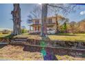Charming two-story home with a welcoming porch, nestled among mature trees at 2114 Whitworth Rd, Cherryville, NC 28021