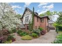 Beautiful brick home with manicured landscaping, brick driveway, and detached garage at 2120 Malvern Rd, Charlotte, NC 28207