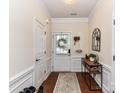 Bright entryway with hardwood floors, white wainscoting, and a decorative console table at 2240 Kensington Station Pkwy, Charlotte, NC 28210