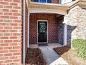 Inviting front entrance features a black door with a decorative wreath and brick facade at 2240 Kensington Station Pkwy, Charlotte, NC 28210