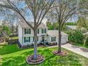 Traditional two-story home with white siding, green shutters, and a beautiful front lawn at 2243 Flint Glenn Ln, Charlotte, NC 28262
