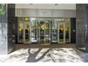 Building entrance featuring revolving doors and glass panels with brick pavers at 230 S Tryon St # 610, Charlotte, NC 28202