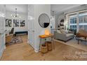 Inviting foyer with hardwood floors, decorative lighting, and an open view to the living room at 230 S Tryon St # 610, Charlotte, NC 28202