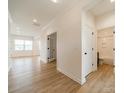 Hallway featuring wood-look flooring, neutral walls and access to a full bath at 3918 Dahlia Dr # 15, Harrisburg, NC 28075