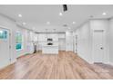 Spacious open-concept kitchen with white cabinets, an island, and hardwood floors at 405 Sullivan Ave, Gastonia, NC 28052