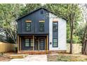 Stylish two-story home with unique architectural design, featuring a covered porch, wood accents, and ample natural light at 411 Cemetery St, Charlotte, NC 28216