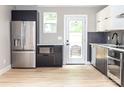 Modern kitchen featuring stainless steel appliances, stylish cabinetry, sleek countertops, and a bright, airy atmosphere at 411 Cemetery St, Charlotte, NC 28216