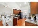 Well-equipped kitchen with granite countertops, stainless steel appliances, and a breakfast bar for casual dining at 5032 Eagles Crest Ln, Gastonia, NC 28056