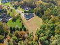 A high angle view of a home with a lush, green backyard bordering dense woods at 5039 Eliza Long Wilkie Dr, Huntersville, NC 28078