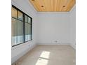 Unfinished room with wood ceiling and large window providing natural light at 5039 Eliza Long Wilkie Dr, Huntersville, NC 28078