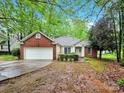 Charming single-story home with brick and vinyl siding, a two-car garage and green lawn at 6520 White Pine Ln, Charlotte, NC 28262