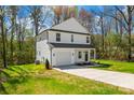 Attractive exterior view of a two-story white home with a well-maintained lawn and a concrete driveway leading to the garage at 701 Applewood St, Kannapolis, NC 28081