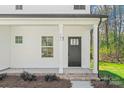 Close-up of the front entrance with a dark door and brick-stepped porch at 701 Applewood St, Kannapolis, NC 28081