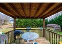 Relaxing covered deck with outdoor seating, grill and views of the backyard at 87 Green Meadows Dr, Taylorsville, NC 28681
