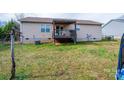 This backyard features a wooden deck, complemented by a well-maintained grassy area at 87 Green Meadows Dr, Taylorsville, NC 28681