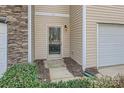 Close up of townhome front door with sidelight, house number, landscaping, and siding details at 9035 Bradstreet Commons Way, Charlotte, NC 28215
