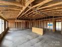 Unfinished interior featuring exposed wood framing with high ceilings and an open-concept design at 1018 Cunningham Farm Dr, Indian Trail, NC 28079