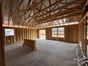 Spacious unfinished room with wood framing, large window openings, and natural light at 1018 Cunningham Farm Dr, Indian Trail, NC 28079
