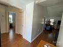 Open hallway showcasing hardwood floors and bright neutral paint color scheme at 1015 Raywood Ct, Matthews, NC 28104