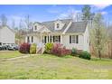 Quaint home exterior with a well-kept lawn and vibrant shrubs and lush yard at 123 Scotch Irish Ln # 136, Troutman, NC 28166