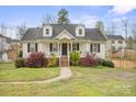 Inviting home with a covered porch, brick foundation and flourishing lawn and landscaping at 123 Scotch Irish Ln # 136, Troutman, NC 28166