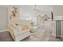 Open-concept living room featuring vaulted ceilings, modern furnishings, and stylish decor at 123 Scotch Irish Ln # 136, Troutman, NC 28166