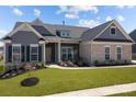 Beautiful single-Gathering home with stone accents, manicured landscaping, and a welcoming entrance with a well-maintained lawn at 12709 Messenger Row, Huntersville, NC 28078