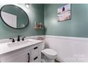 Chic half bathroom with stylish vanity, modern fixtures, and nautical decor at 1274 Fishing Creek Rd # 134, Clover, SC 29710