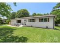 Exterior shot of a charming one-story home with a well-maintained lawn and eye-catching curb appeal and a new garage at 1315 Vickie Ln, Matthews, NC 28104