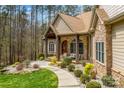 Landscaped walkway leading to the front door of this home with stacked stone and timber accents at 135 Frostcliff Ln, Mooresville, NC 28117