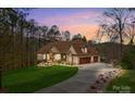 Well-manicured lawn and long driveway of this home, with a view of the attached two car garage at 135 Frostcliff Ln, Mooresville, NC 28117
