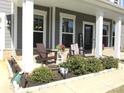 Cozy front porch with chairs, potted plants, and a welcome sign offers a relaxing outdoor space at 19412 Bird Meadow Dr, Huntersville, NC 28078