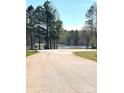 Picturesque view of a quiet community road leading to a serene lake at 201 Fancy Lady Ct, York, SC 29745