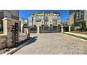 Gated community entrance with brick pillars and an automated gate, offering enhanced security and privacy at 2916 Grand Union Way, Charlotte, NC 28209