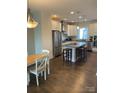 Spacious kitchen featuring a large island with seating, stainless steel appliances, and hardwood floors at 2916 Grand Union Way, Charlotte, NC 28209