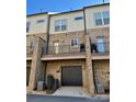 Townhouse exterior featuring private balconies, garage access, and brick facade at 2916 Grand Union Way, Charlotte, NC 28209