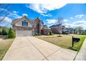 Two-story brick and stone home with a spacious driveway and well-kept lawn at 324 Kerrydale Ct # 106, Clover, SC 29710